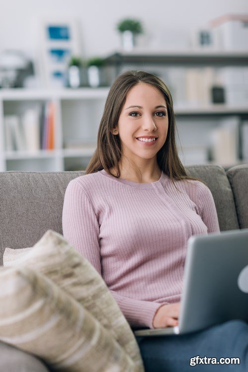 Beautiful young girl works with the smartphone and a laptop - 18xUHQ JPEG Photo Stock