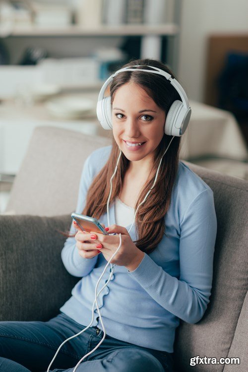 Beautiful young girl works with the smartphone and a laptop - 18xUHQ JPEG Photo Stock