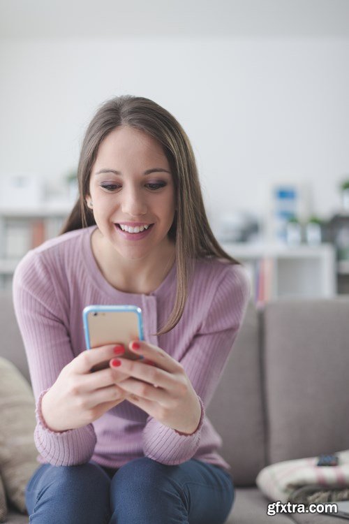 Beautiful young girl works with the smartphone and a laptop - 18xUHQ JPEG Photo Stock