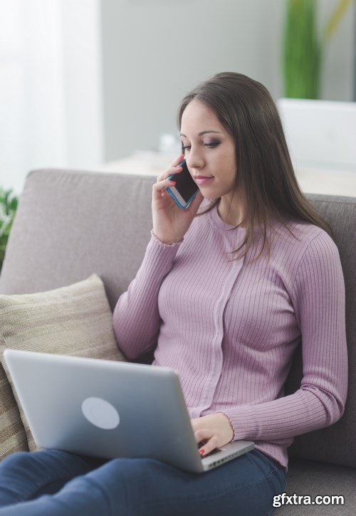 Beautiful young girl works with the smartphone and a laptop - 18xUHQ JPEG Photo Stock