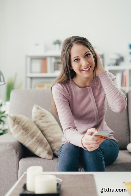 Beautiful young girl works with the smartphone and a laptop - 18xUHQ JPEG Photo Stock