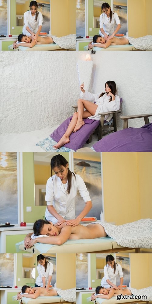 Young woman enjoying back massage in beauty spa salon