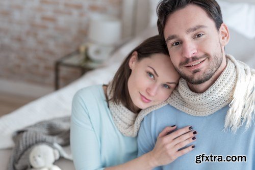 Happy young couple in a cozy bedroom - 20xUHQ JPEG Photo Stock