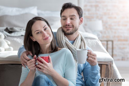 Happy young couple in a cozy bedroom - 20xUHQ JPEG Photo Stock