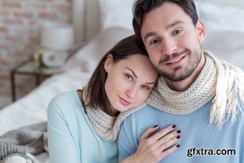 Happy young couple in a cozy bedroom - 20xUHQ JPEG Photo Stock