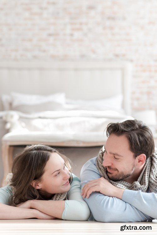 Happy young couple in a cozy bedroom - 20xUHQ JPEG Photo Stock