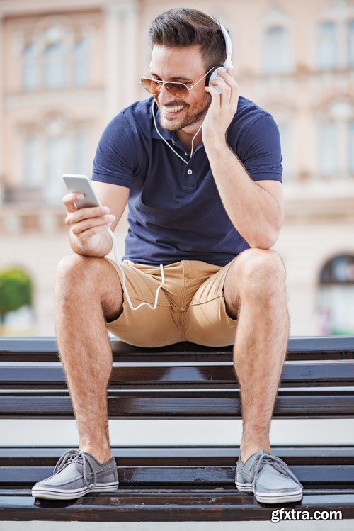 Smiling handsome guy listening to music - 24xUHQ JPEG Photo Stock