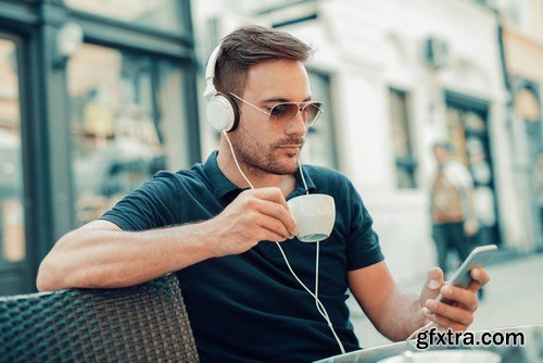 Smiling handsome guy listening to music - 24xUHQ JPEG Photo Stock