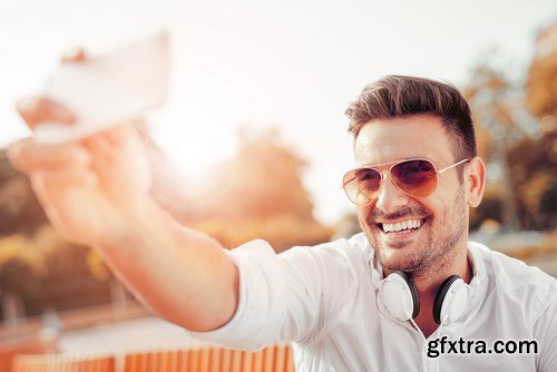 Smiling handsome guy listening to music - 24xUHQ JPEG Photo Stock