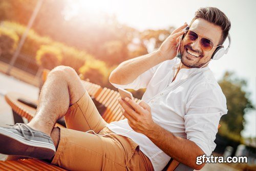 Smiling handsome guy listening to music - 24xUHQ JPEG Photo Stock