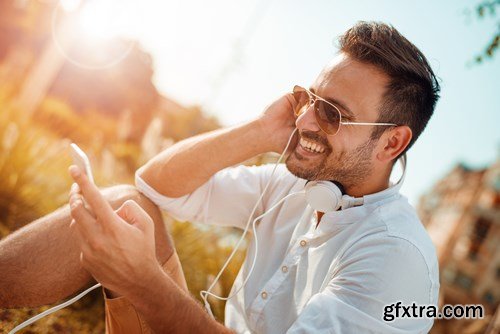 Smiling handsome guy listening to music - 24xUHQ JPEG Photo Stock