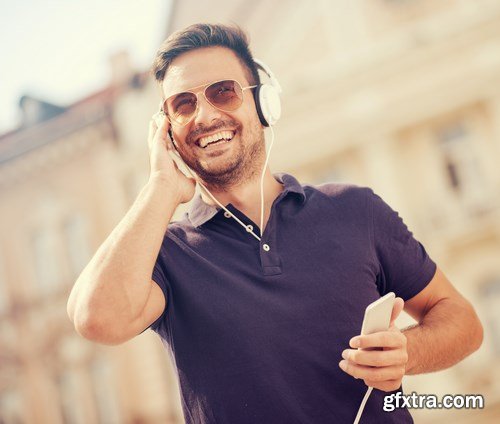 Smiling handsome guy listening to music - 24xUHQ JPEG Photo Stock