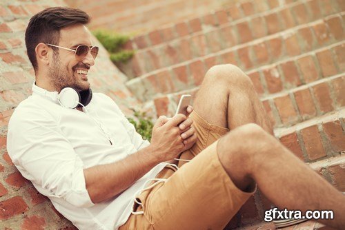 Smiling handsome guy listening to music - 24xUHQ JPEG Photo Stock