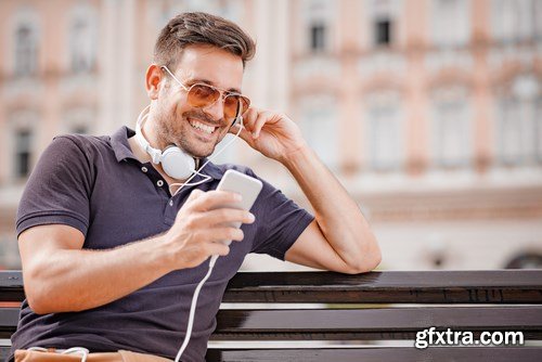 Smiling handsome guy listening to music - 24xUHQ JPEG Photo Stock