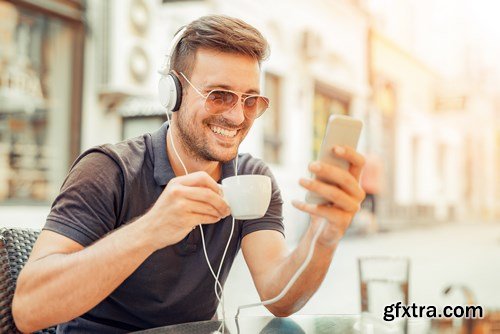 Smiling handsome guy listening to music - 24xUHQ JPEG Photo Stock