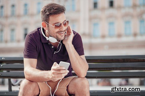 Smiling handsome guy listening to music - 24xUHQ JPEG Photo Stock