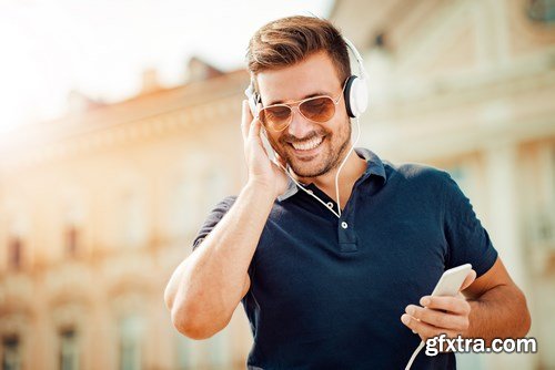 Smiling handsome guy listening to music - 24xUHQ JPEG Photo Stock