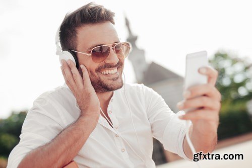 Smiling handsome guy listening to music - 24xUHQ JPEG Photo Stock