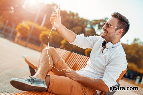 Smiling handsome guy listening to music - 24xUHQ JPEG Photo Stock