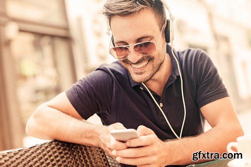 Smiling handsome guy listening to music - 24xUHQ JPEG Photo Stock