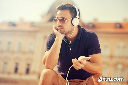 Smiling handsome guy listening to music - 24xUHQ JPEG Photo Stock