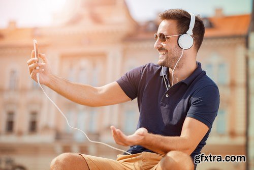 Smiling handsome guy listening to music - 24xUHQ JPEG Photo Stock