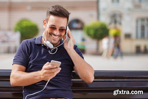 Smiling handsome guy listening to music - 24xUHQ JPEG Photo Stock