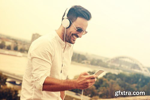 Smiling handsome guy listening to music - 24xUHQ JPEG Photo Stock