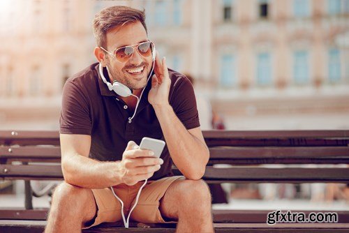 Smiling handsome guy listening to music - 24xUHQ JPEG Photo Stock