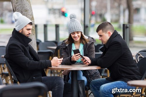 Group of students is sitting in an outdoor cafe and using laptop - 14xUHQ JPEG Photo Stock