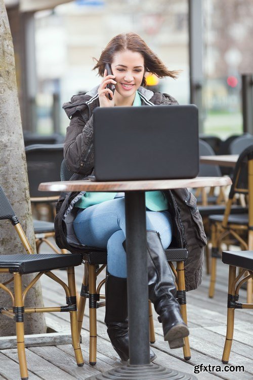 Group of students is sitting in an outdoor cafe and using laptop - 14xUHQ JPEG Photo Stock