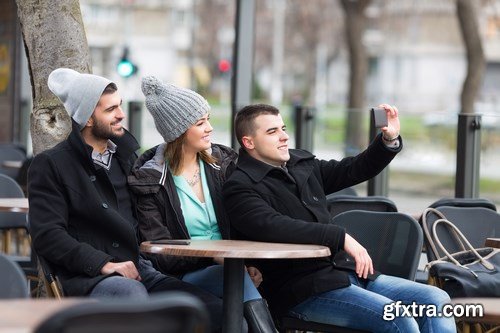 Group of students is sitting in an outdoor cafe and using laptop - 14xUHQ JPEG Photo Stock