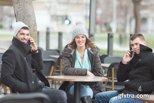 Group of students is sitting in an outdoor cafe and using laptop - 14xUHQ JPEG Photo Stock