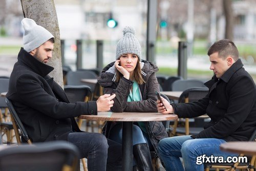 Group of students is sitting in an outdoor cafe and using laptop - 14xUHQ JPEG Photo Stock