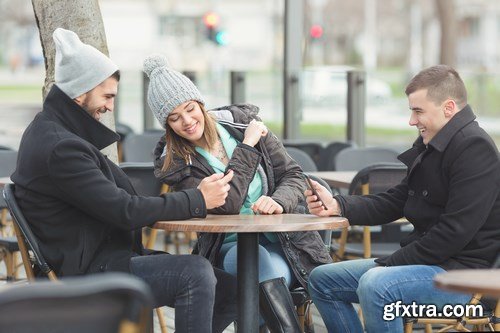 Group of students is sitting in an outdoor cafe and using laptop - 14xUHQ JPEG Photo Stock