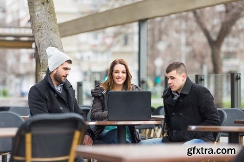 Group of students is sitting in an outdoor cafe and using laptop - 14xUHQ JPEG Photo Stock