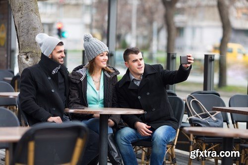 Group of students is sitting in an outdoor cafe and using laptop - 14xUHQ JPEG Photo Stock