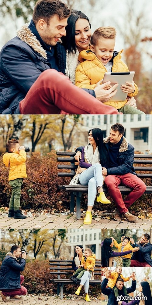 Little boy photographing his parents in the park