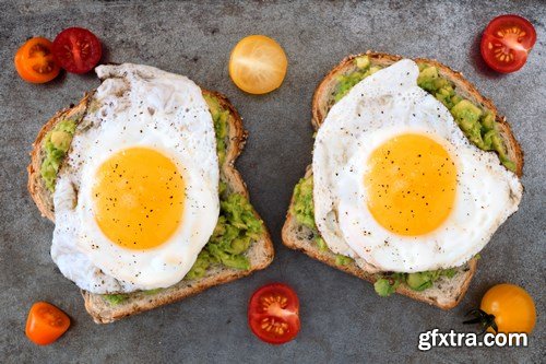 Healthy avocado, egg open sandwiches on a plate with cherry tomatoes on a rustic wood background - 15xUHQ JPEG