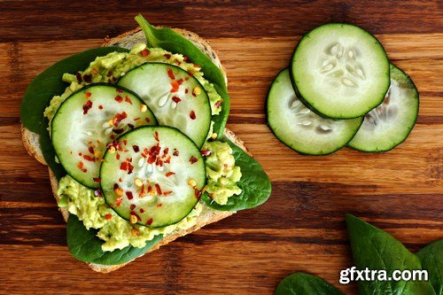 Healthy avocado, egg open sandwiches on a plate with cherry tomatoes on a rustic wood background - 15xUHQ JPEG