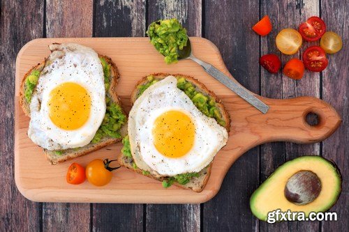 Healthy avocado, egg open sandwiches on a plate with cherry tomatoes on a rustic wood background - 15xUHQ JPEG