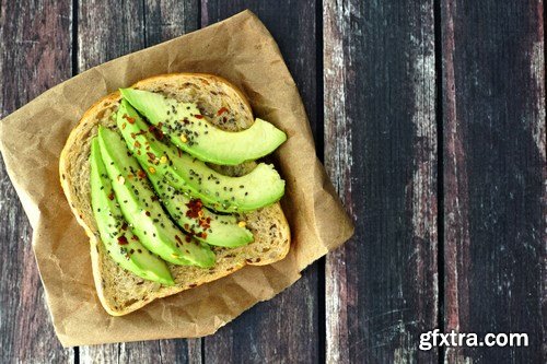 Healthy avocado, egg open sandwiches on a plate with cherry tomatoes on a rustic wood background - 15xUHQ JPEG