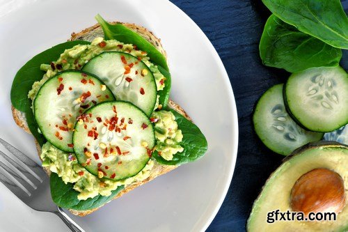 Healthy avocado, egg open sandwiches on a plate with cherry tomatoes on a rustic wood background - 15xUHQ JPEG
