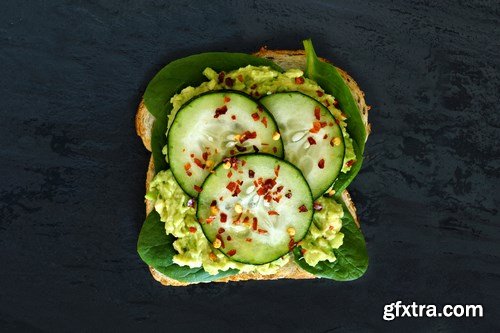 Healthy avocado, egg open sandwiches on a plate with cherry tomatoes on a rustic wood background - 15xUHQ JPEG