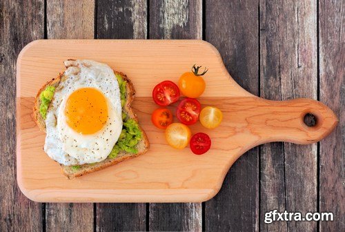 Healthy avocado, egg open sandwiches on a plate with cherry tomatoes on a rustic wood background - 15xUHQ JPEG