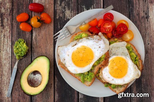 Healthy avocado, egg open sandwiches on a plate with cherry tomatoes on a rustic wood background - 15xUHQ JPEG