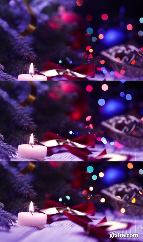 Candle and Christmas decorations on a Christmas tree with blinking garlands