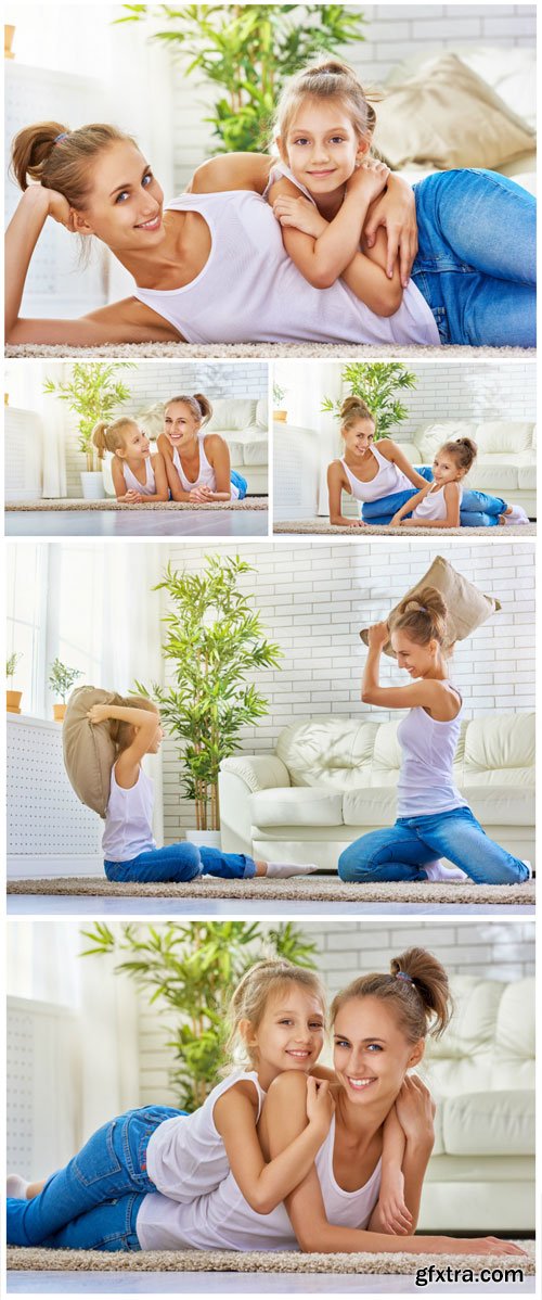 Happy mother and daughter playing in the room