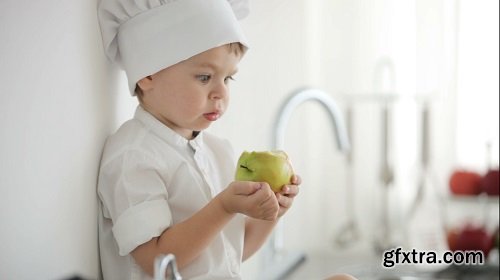 Boy eating an apple and smiling close up