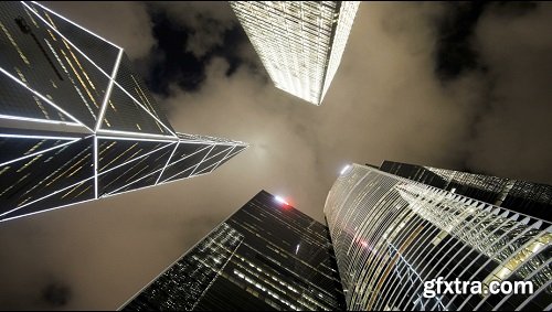 Low angle view of clouds moving over tall office buildings including the ba